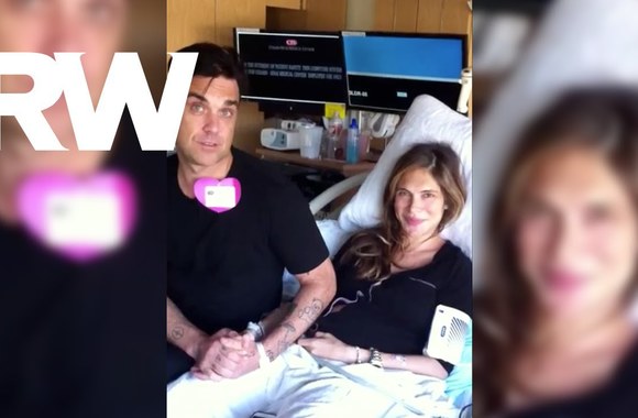 VIDEO kadras: Robbie Williamso ir jo žmonos žinutė gerbėjams iš karto po gimdymo